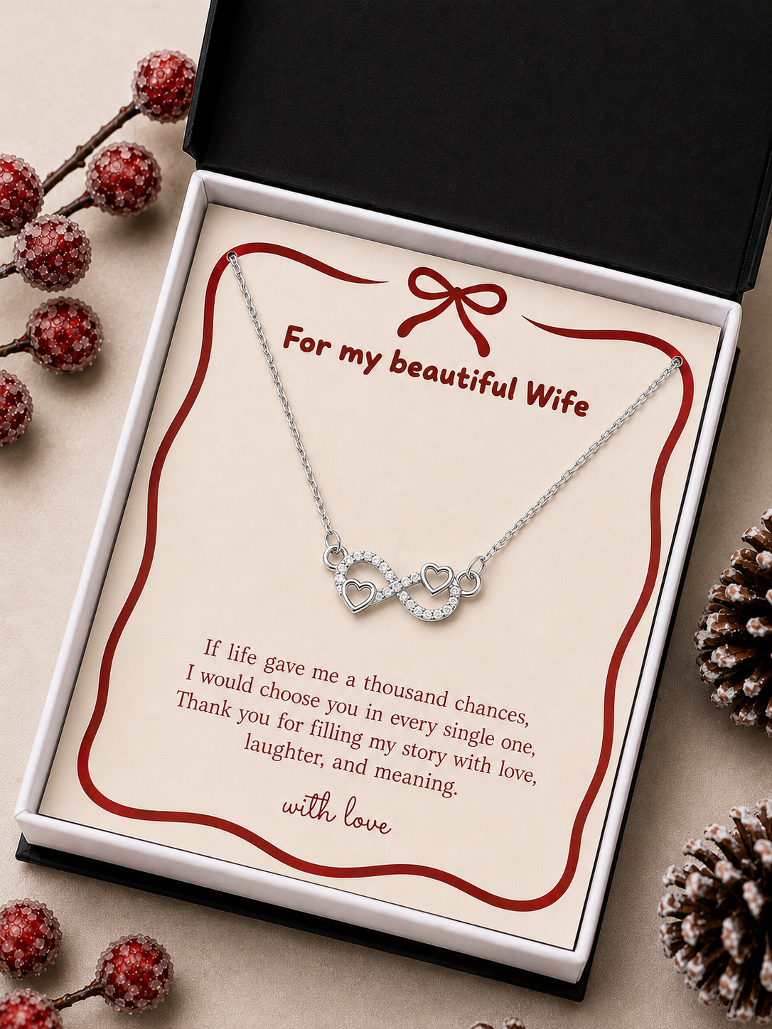 Infinity heart pendant necklace arranged on a romantic message card