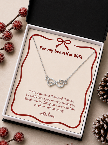 Infinity heart pendant necklace arranged on a romantic message card