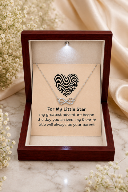Sentimental heart infinity pendant necklace presented with a heartfelt card celebrating the joy of becoming a parent