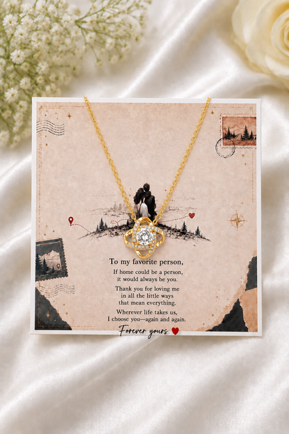 Romantic gold-tone heart necklace displayed over a sentimental love message card with a meaningful relationship message.