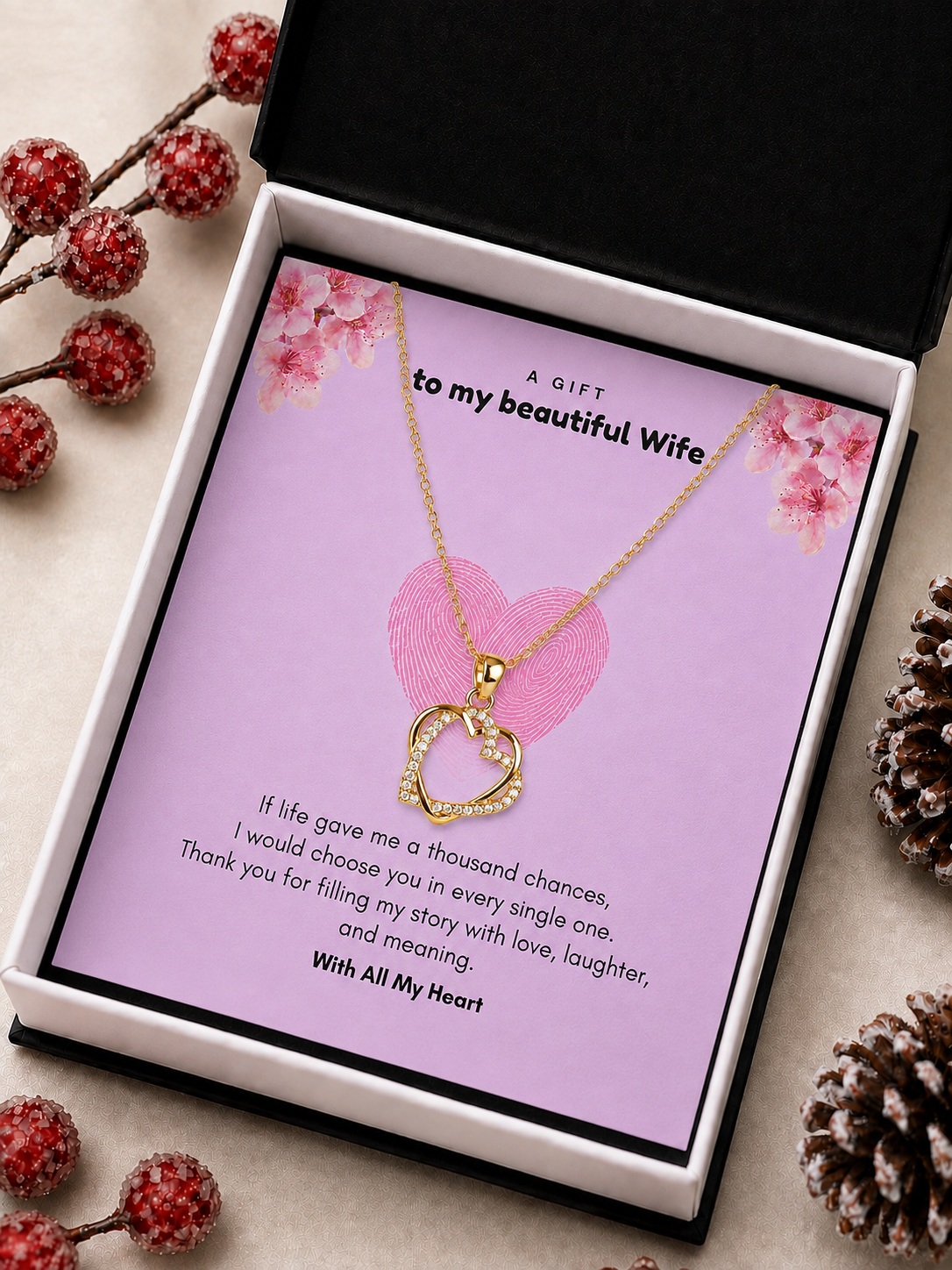 tone double heart pendant necklace for wife inside a standard black and white gift box decorated with pinecones.