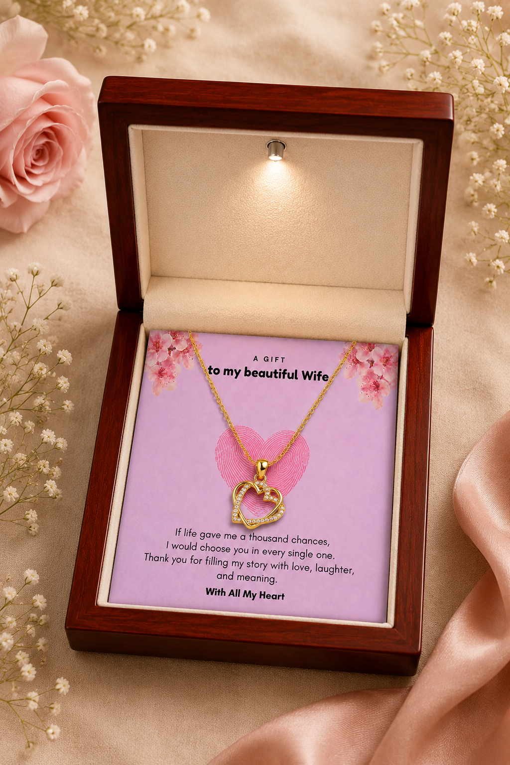 Close-up detail of the silver-tone double heart pendant sparkling with crystal-style accents.