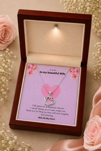 Silver-tone interlocking hearts necklace for wife showcased in a wooden gift box against a neutral background.