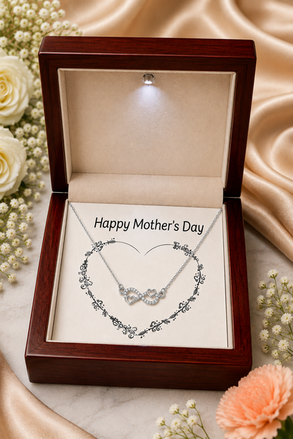Silver-tone heart infinity necklace gift surrounded by flowers