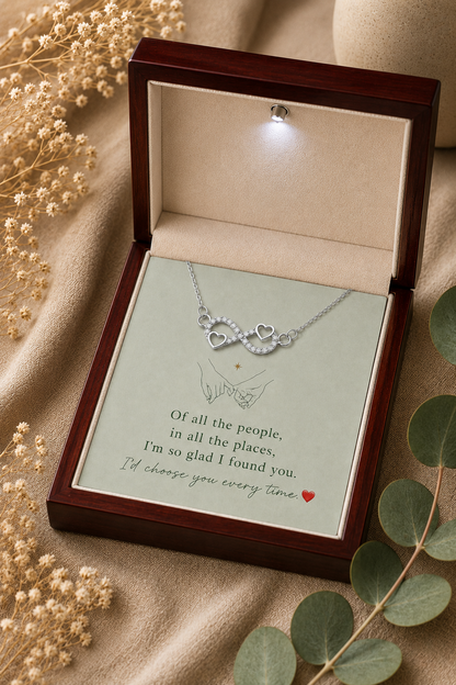 Silver-tone heart infinity necklace with clear accents and wooden gift presentation