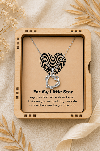 Silver-tone heart pendant with clear accents presented on emotional message card
