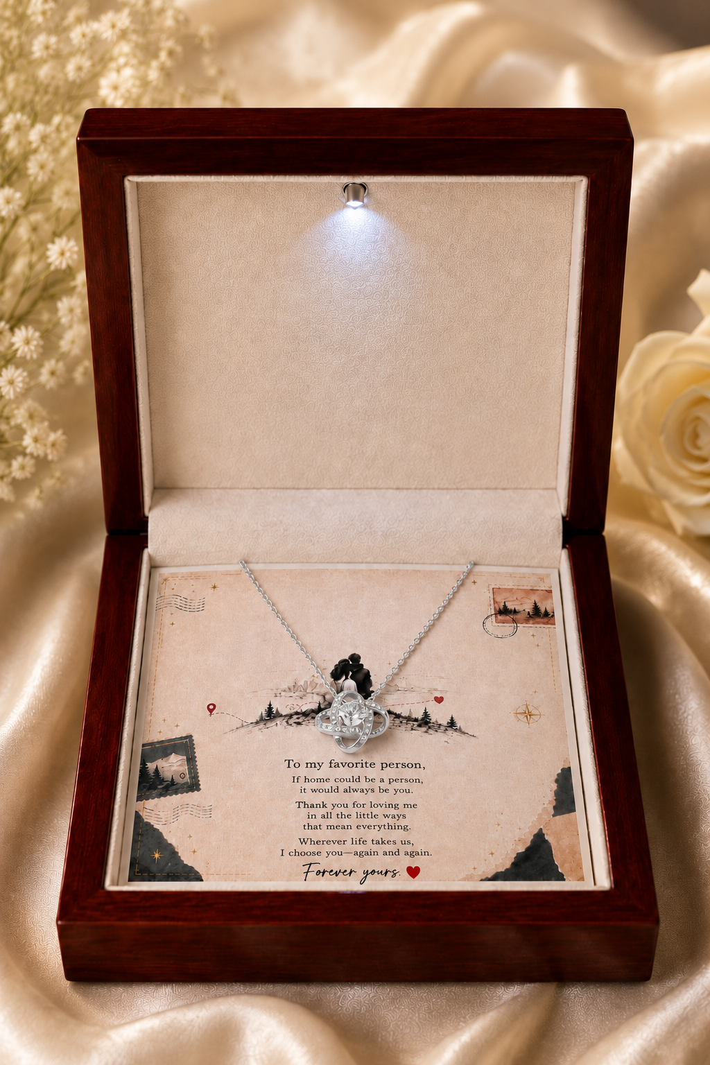 Silver-tone pendant necklace with crystal-style accents shown on a love-themed message card inside a gift box.