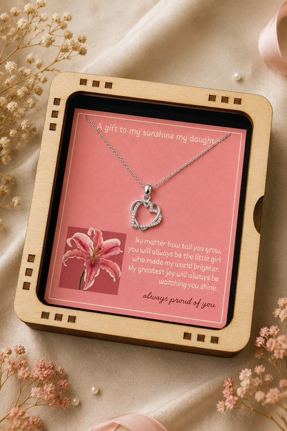 Silver-tone daughter necklace with intertwined heart pendant presented on pink message card