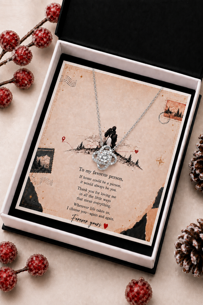 Silver-tone heart pendant necklace with clear stone and crystal-style accents displayed with romantic message card.