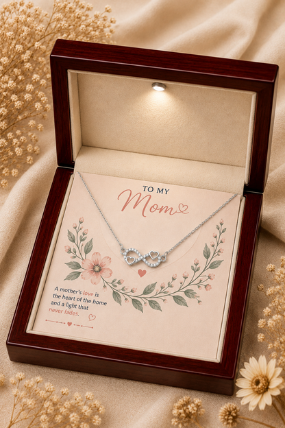 Silver-tone infinity heart necklace displayed in LED wooden presentation box