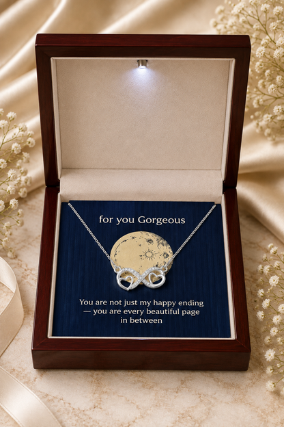 Silver-tone infinity heart pendant with clear stone-style accents and gift card