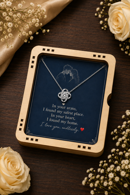 Silver-tone interlocking pendant necklace displayed on navy message card