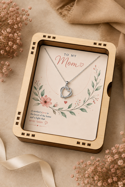 Silver-tone Mom heart necklace displayed on floral gift card