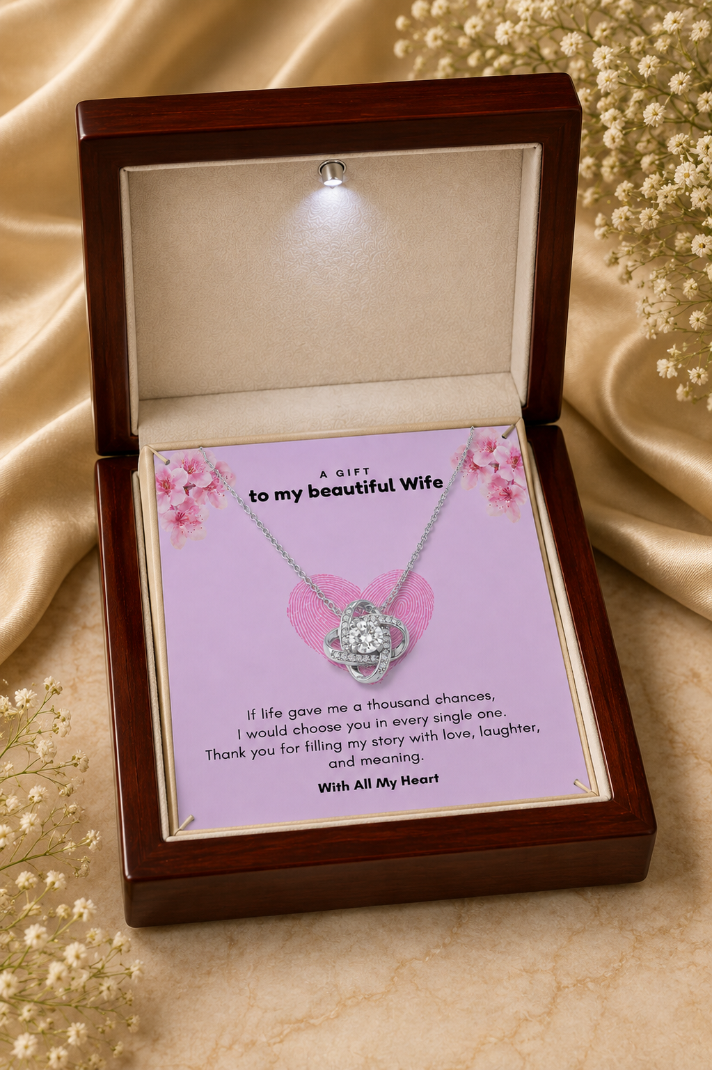 Silver-tone wife necklace displayed in wooden presentation box with LED light