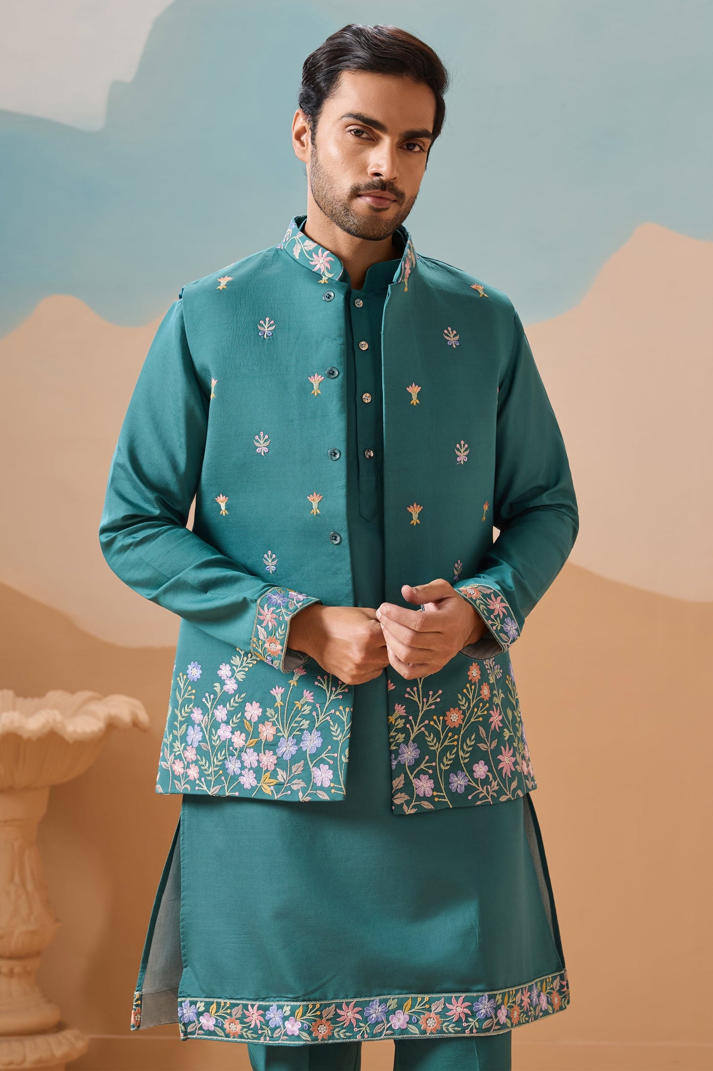 Teal kurta with koti showcasing multi thread sequence work
