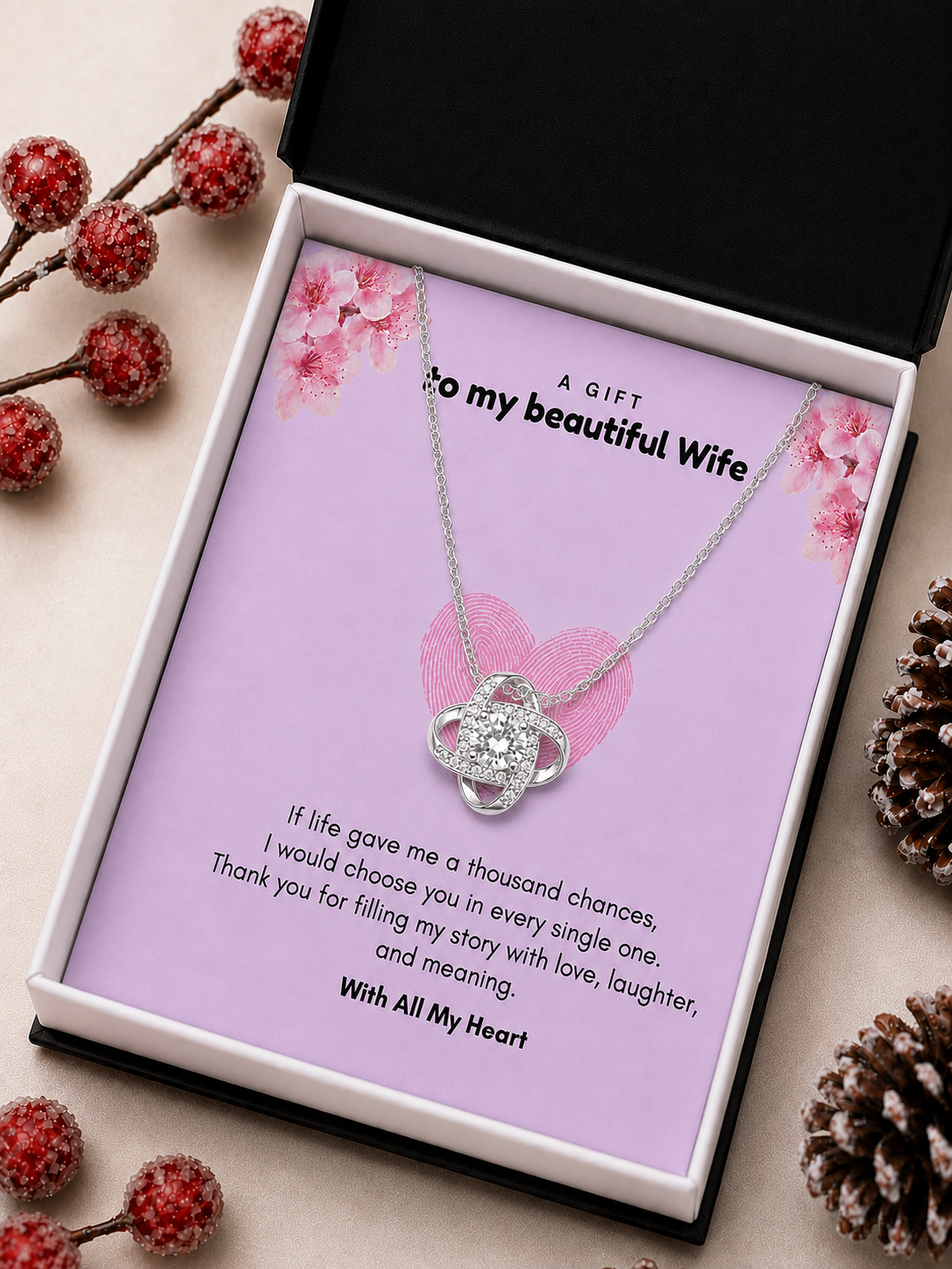 Silver-tone intertwined heart necklace displayed on romantic wife gift card