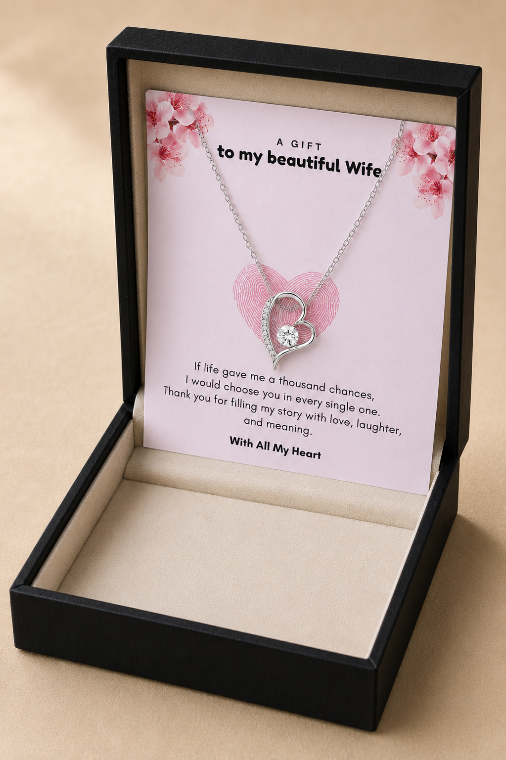 Gold-tone alloy heart pendant necklace on pink floral message card for anniversary gift.